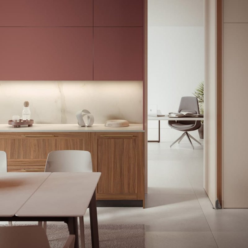 Cuisine moderne avec placards bordeaux, îlot en bois, table à manger et bureau visible en arrière-plan